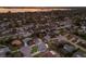 Aerial view of a neighborhood with homes, streets, trees, and the bay in the background at sunset at 7404 13Th Avenue W Dr, Bradenton, FL 34209