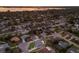 Aerial view of a residential neighborhood with a lake in the background; property highlighted in white at 7404 13Th Avenue W Dr, Bradenton, FL 34209