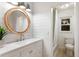 Stylish bathroom with decorative mirror, shiplap walls, and modern fixtures at 7404 13Th Avenue W Dr, Bradenton, FL 34209