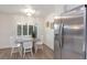 Charming dining area featuring a modern stainless steel refrigerator and bright window views at 7404 13Th Avenue W Dr, Bradenton, FL 34209