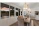 Bright dining area with large windows offering views of the landscaped backyard and a beaded chandelier at 7404 13Th Avenue W Dr, Bradenton, FL 34209