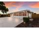 Enclosed patio space with many windows and a concrete patio surrounded by landscaping at 7404 13Th Avenue W Dr, Bradenton, FL 34209