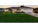 Charming single-story home with lush lawn, manicured landscaping, and a welcoming two-car garage at 7404 13Th Avenue W Dr, Bradenton, FL 34209