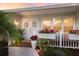 Inviting front porch featuring double doors, decorative wreaths, and charming floral accents at 7404 13Th Avenue W Dr, Bradenton, FL 34209