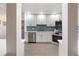 Well-appointed kitchen with white cabinets, stainless steel appliances, and stylish blue tile backsplash at 7404 13Th Avenue W Dr, Bradenton, FL 34209