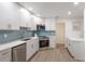 Stylish kitchen featuring stainless steel appliances, white cabinets, and modern finishes at 7404 13Th Avenue W Dr, Bradenton, FL 34209
