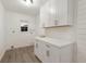 Well-organized laundry room with sleek cabinets, countertops, and ample storage space at 7404 13Th Avenue W Dr, Bradenton, FL 34209