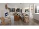 Open-concept living room with cozy seating, a modern fireplace, and a dining area at 7404 13Th Avenue W Dr, Bradenton, FL 34209