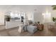 Bright living room showcasing a comfortable gray couch and open access to a well-lit kitchen at 7404 13Th Avenue W Dr, Bradenton, FL 34209