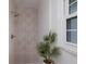 Stylish shower with decorative tile and a bright window at 7404 13Th Avenue W Dr, Bradenton, FL 34209