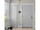 Bright entryway featuring a white door, tiled floor, and natural light from the window at 766 13Th S Ave, St Petersburg, FL 33701