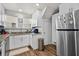 Bright kitchen features white cabinets, stainless steel appliances, and wood-look flooring at 766 13Th S Ave, St Petersburg, FL 33701
