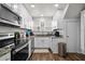 Bright kitchen features white cabinets, stainless steel appliances, and wood-look flooring at 766 13Th S Ave, St Petersburg, FL 33701