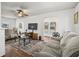 A living room with neutral-colored sofas and modern décor with dark-stained wood-look floors at 766 13Th S Ave, St Petersburg, FL 33701