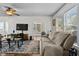 A living room with neutral-colored sofa and modern décor with dark-stained wood-look floors at 766 13Th S Ave, St Petersburg, FL 33701