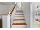 Classic staircase with white risers and wood treads, bathed in natural light from a nearby window at 766 13Th S Ave, St Petersburg, FL 33701