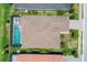 Aerial view of property showing roof, screened pool and lush landscaping at 8020 Clearwater Ct, Sarasota, FL 34241