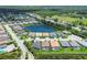 Aerial view featuring beautiful neighborhood, multiple homes, a lake, and green landscapes at 8020 Clearwater Ct, Sarasota, FL 34241