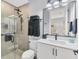 This is a modern-style bathroom with stand-up shower, tile floor, and dark fixtures at 8020 Clearwater Ct, Sarasota, FL 34241