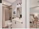 Bathroom featuring tiled shower/tub, white vanity with dark fixtures, and neutral wall color at 8020 Clearwater Ct, Sarasota, FL 34241