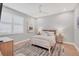 This is a modern bedroom with wood-style floors, ceiling fan and large windows at 8020 Clearwater Ct, Sarasota, FL 34241