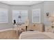 A bedroom features an office space with a white desk and chair by the window at 8020 Clearwater Ct, Sarasota, FL 34241