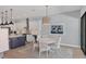 An open dining area is set between the kitchen and the outdoor living area and features a round table at 8020 Clearwater Ct, Sarasota, FL 34241