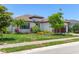 A charming single-story home with landscaped yard, a tile roof, and an attached garage at 8020 Clearwater Ct, Sarasota, FL 34241