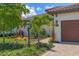 Close up of the exterior, highlighting the well-kept landscaping and paver walkway leading to the front door at 8020 Clearwater Ct, Sarasota, FL 34241