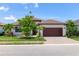 Charming one-story home with a tile roof, brick driveway, well manicured lawn, and attached two car garage at 8020 Clearwater Ct, Sarasota, FL 34241