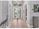 Inviting foyer with wood flooring, a modern light fixture, and a view of the double door entry at 8020 Clearwater Ct, Sarasota, FL 34241