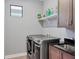 This is a laundry room with side-by-side washer/dryer, folding table and sink at 8020 Clearwater Ct, Sarasota, FL 34241
