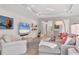 Spacious living room with a ceiling fan, shiplap walls, access to other rooms, and comfortable seating at 8020 Clearwater Ct, Sarasota, FL 34241