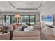 Comfortable living room with plush seating, a ceiling fan, shiplap walls, and access to the backyard pool at 8020 Clearwater Ct, Sarasota, FL 34241
