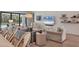 Stylish living room features a large sectional sofa, shiplap walls, and access to the pool at 8020 Clearwater Ct, Sarasota, FL 34241