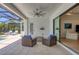 Inviting outdoor patio features comfortable seating, fan, and access to screened-in pool at 8020 Clearwater Ct, Sarasota, FL 34241