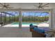 Relaxing screened-in patio with pool view, comfortable seating, and ceiling fans at 8020 Clearwater Ct, Sarasota, FL 34241