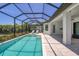 Screened in pool area with outdoor seating and lush landscaping in the backyard for privacy at 8020 Clearwater Ct, Sarasota, FL 34241