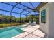 Relaxing screened-in pool and spa with comfortable lounge chairs on the patio at 8020 Clearwater Ct, Sarasota, FL 34241