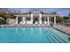 Beautiful community pool with pool house and several lounge chairs for relaxing in the sun at 8020 Clearwater Ct, Sarasota, FL 34241