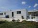 Back exterior view of home featuring steps up to the entrance, trash receptacles, and outdoor space at 845 S Green Cir, Venice, FL 34285
