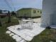 Inviting backyard patio area featuring white outdoor furniture, great for outdoor relaxation and dining at 845 S Green Cir, Venice, FL 34285