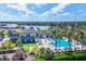 Expansive aerial view of the community, highlighting the pool, clubhouse, playground, and serene lake at 8962 Baroque Ter, Sarasota, FL 34240
