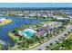 Aerial view featuring community pool, clubhouse, lakes, and well-manicured lawns at 8962 Baroque Ter, Sarasota, FL 34240