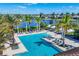 Aerial view of a resort-style pool and amenity center with lush greenery and tranquil lake views at 8962 Baroque Ter, Sarasota, FL 34240