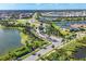 Aerial view of the community with manicured streets, lush landscaping, lakes, and beautiful homes at 8962 Baroque Ter, Sarasota, FL 34240