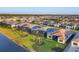 Aerial view of a community featuring well-maintained homes, landscaping, and a lake at 8962 Baroque Ter, Sarasota, FL 34240