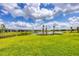 Scenic backyard view featuring a lush lawn, lake, and well-manicured landscaping at 8962 Baroque Ter, Sarasota, FL 34240