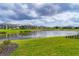 Picturesque view of a backyard with a pond surrounded by a well maintained community at 8962 Baroque Ter, Sarasota, FL 34240