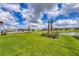 Enjoy the beautiful view of the lake with tropical landscaping in this home's backyard at 8962 Baroque Ter, Sarasota, FL 34240